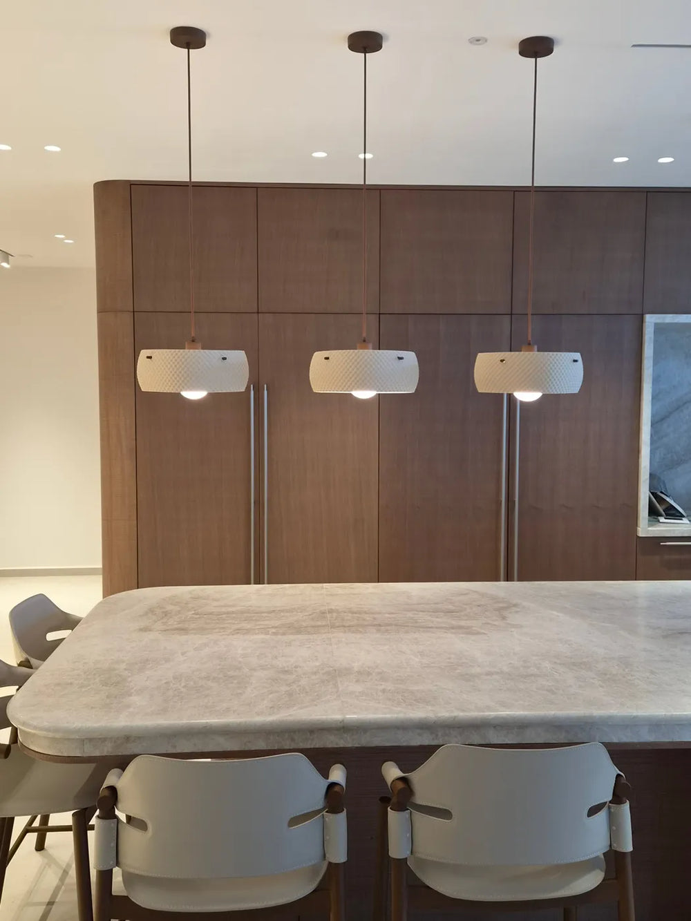 Three Negev pendants over a stone kitchen island