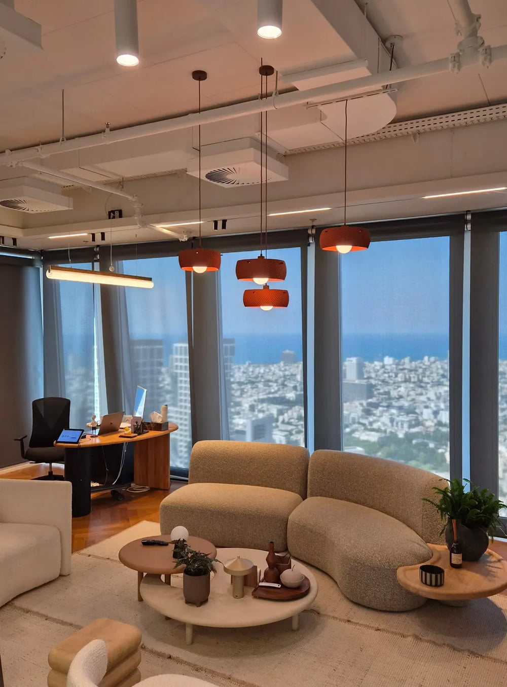 Three terracotta Negev pendants in an office overlooking the sea